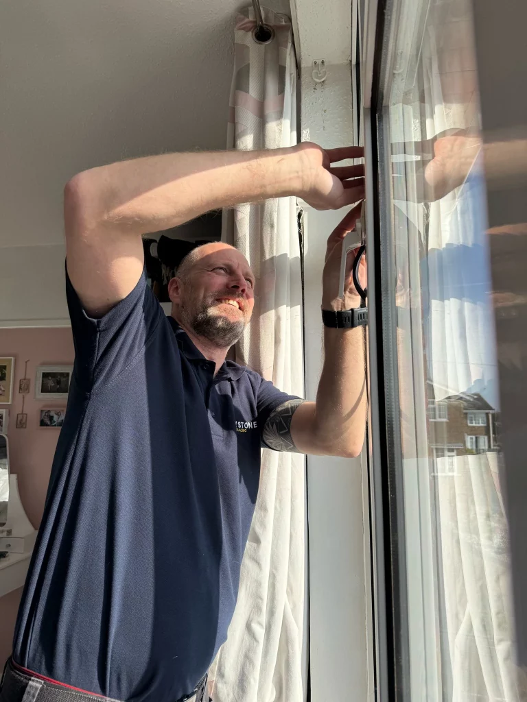 Keystone Glazing installer fitting a double-glazed window in a residential home.