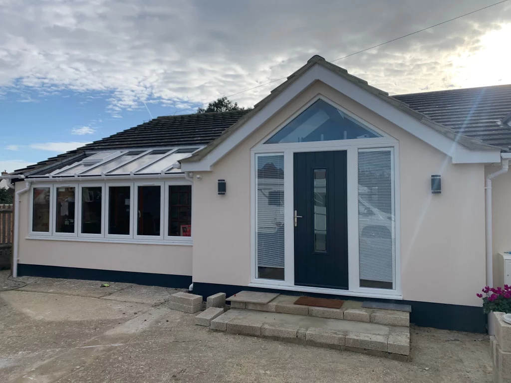 Modern front door with glazed side panels and a conservatory in Bognor Regis.