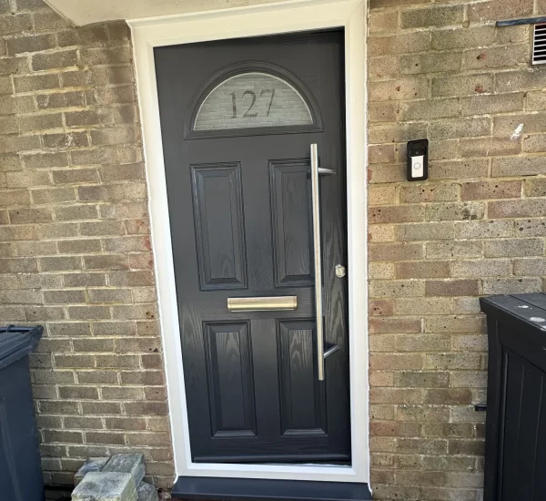 Anthracite grey composite front door fitted by Keystone Glazing in Emsworth, Hampshire, featuring chrome hardware and a modern vertical handle.
