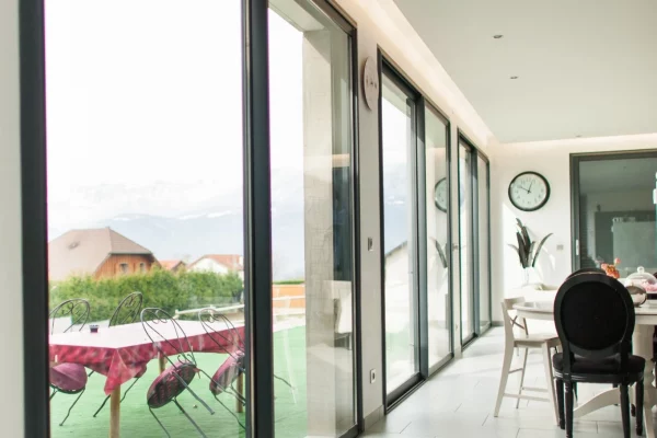 Modern lounge with large Optio BSC94 inline sliding doors leading to a garden patio.