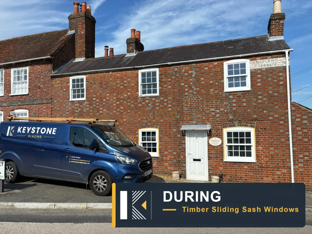 Brick terrace with white-framed timber windows and a Keystone Glazing van parked outside in Hamble